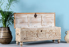 Side angle image with open lid of a Hand-carved mango wood chest box with floral motifs, whitewashed finish, and iron handles – vintage home accessory for rustic and elegant interiors.