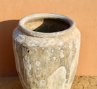 Close up image of an antique Indian clay vase with natural finish – a Bali style clay vase perfect for Indian home decoration and bohemian interior styling.
