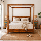 Lifestyle scene of a set of two hand painted bedside tables Maya with floral motifs next to four poster bed Wular; sustainable furniture made of recycled wood, 45 × 35 × 70 cm.