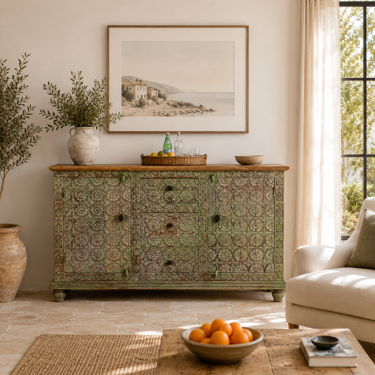 Lifestyle image of a carved wooden furniture sideboard with floral hand-carving and distressed finish, vintage style cabinet made from mango wood, 150 × 40 × 90 cm.