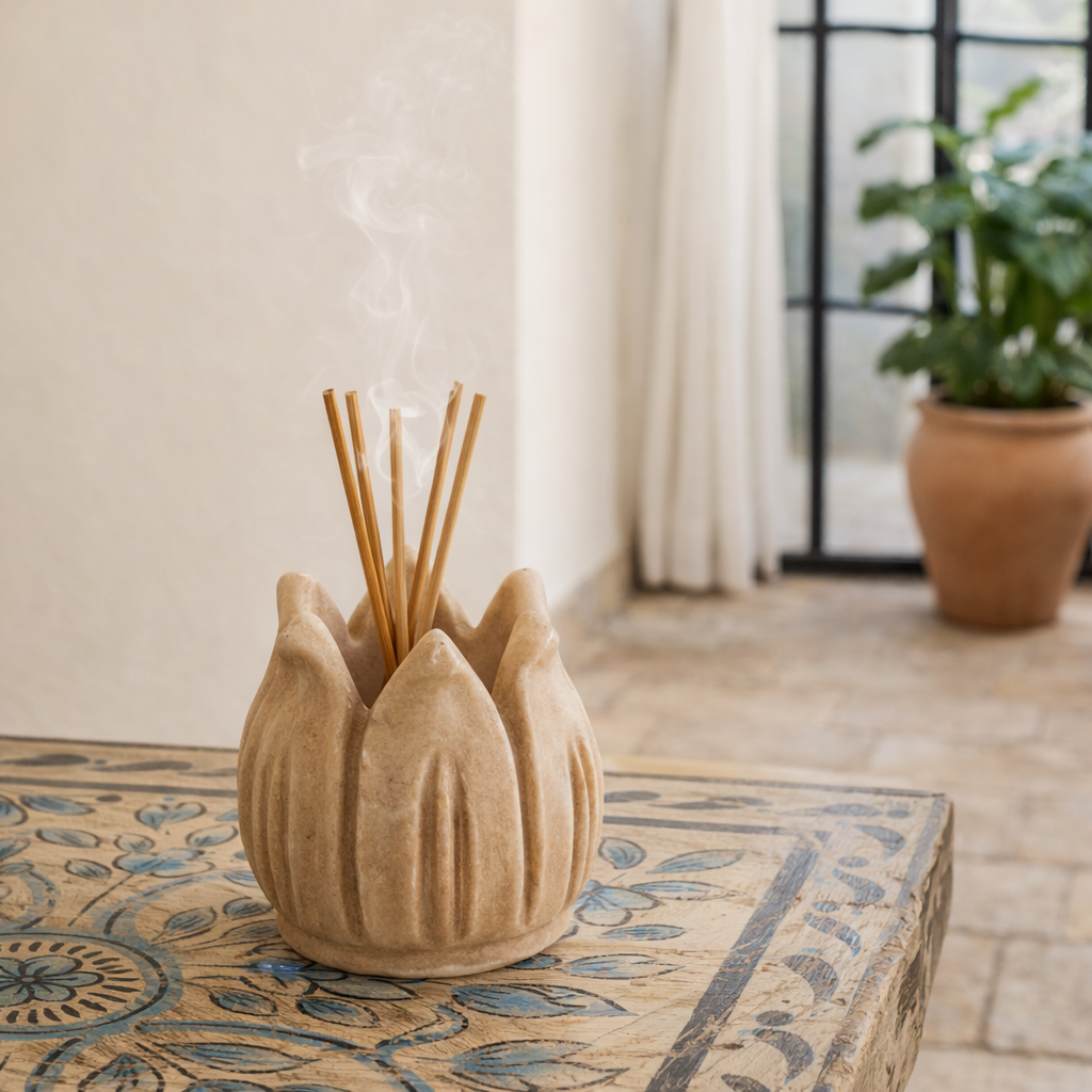 Lifestyle image of a hand-carved marble tealight holder Krishav with pointed petal shape. A vintage home accessory and unique Indian decoration, perfect for candles, tealights, or home fragrances in vintage home decor settings.