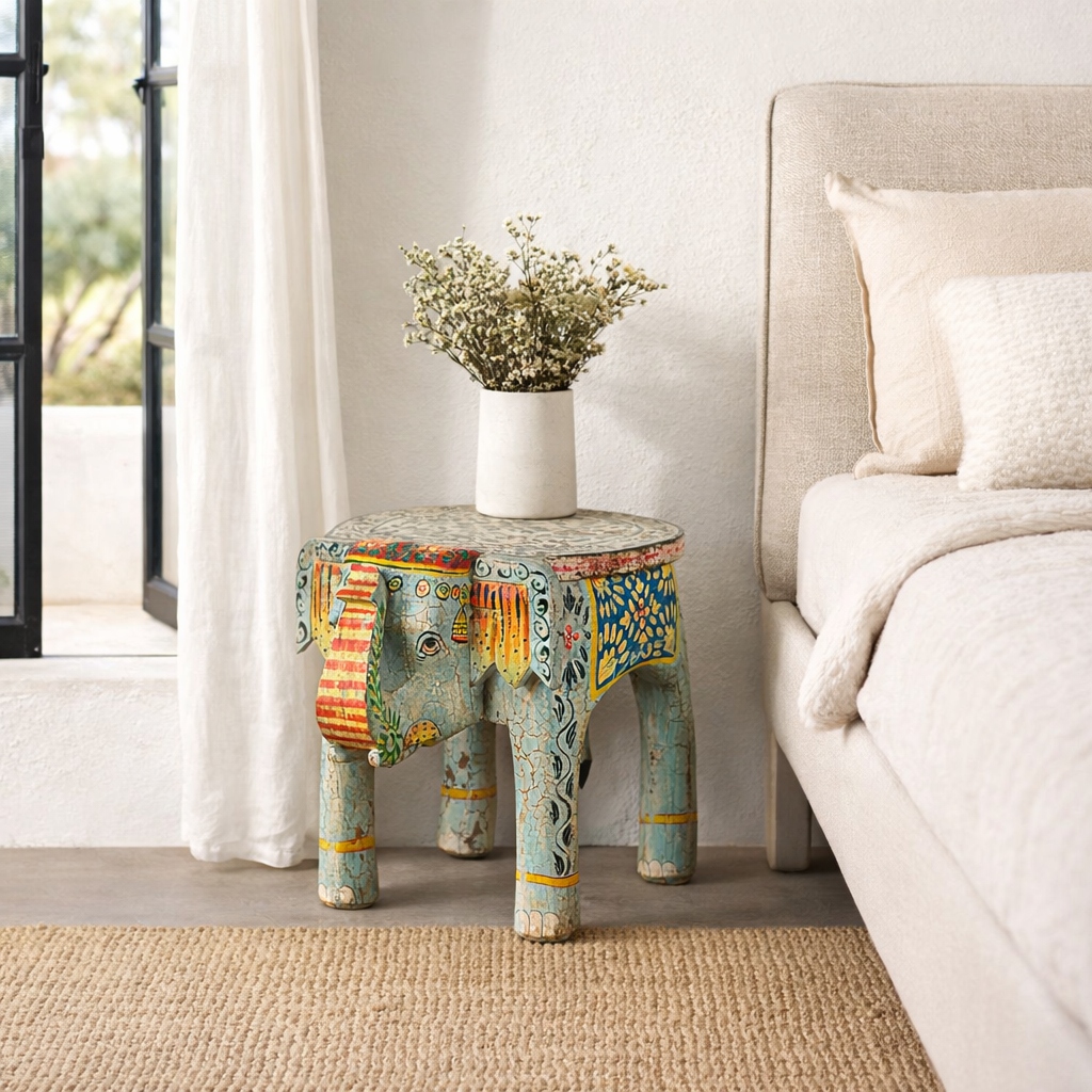 Lifestyle imagination of a hand-painted wooden elephant-shaped side table with Indian folk art motifs and floral details, perfect for vintage or global home decor.