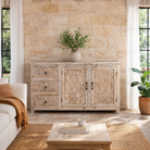 Lifestyle image of a hand‑carved vintage style mango wood sideboard with distressed floral lattice panels, 150 × 40 × 90 cm.