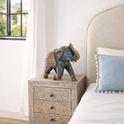 Lifestyle imagination of a hand‑painted blue wooden elephant decoration with colourful folk art motifs, a unique Indian home accessory and vintage home decor accent.