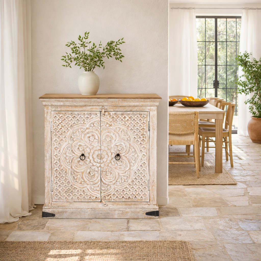 Lifestyle image of a of a whitewashed mango wood sideboard with hand-carved floral patterns; compact carved sideboard for vintage interiors, 90 × 90 × 40 cm.
