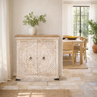 Lifestyle image of a of a whitewashed mango wood sideboard with hand-carved floral patterns; compact carved sideboard for vintage interiors, 90 × 90 × 40 cm.