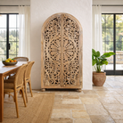 Lifestyle image of a hand-carved mango wood wardrobe, a statement piece of bedroom furniture ideal for a bohemian interior.