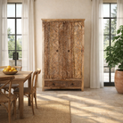 Lifestyle image of a mango wood wardrobe with hand-carved floral detailing, Indian carved wooden furniture with bottom drawer, 105 × 40 × 180 cm.