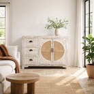 Lifestyle image of a handcrafted mango wood dresser with floral carvings and rattan cane inserts, bohemian interior and rattan furniture style, whitewashed finish, 120 × 40 × 92 cm.