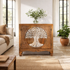 Lifestyle image of a carved mango wood furniture cabinet with Tree of Life design and whitewashed finish, 90 × 40 × 90 cm.