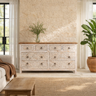 Lifestyle image of a hand-carved mango wood sideboard with elephant motifs and whitewashed finish; ideal for vintage home decor, 153 × 80 × 40 cm.