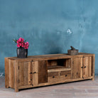 Side view image of a sustainable driftwood sideboard with two drawers, open shelf, and cabinets; made from reclaimed wood, 200 × 45 × 60 cm.