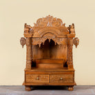 Meher hand carved mango wood mandir with traditional Indian temple details and two small drawers.