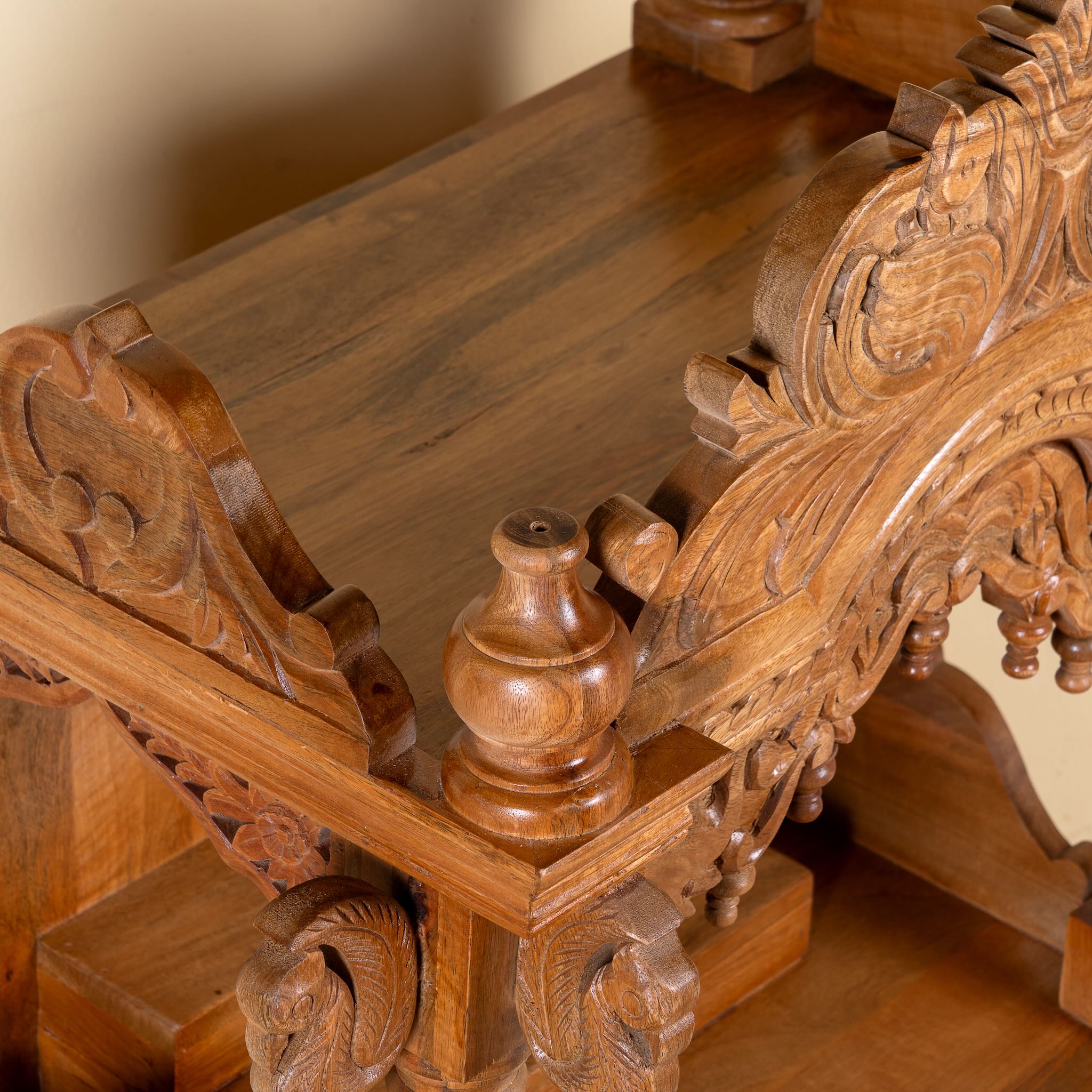 Close up image of a Meher hand carved mango wood mandir with traditional Indian temple details and two small drawers.