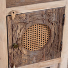 Close up image of a Milan hand carved reclaimed wood nightstands with woven rattan inserts, drawer storage, cabinet doors, and warm natural boho style design.