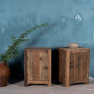Side angle image of a reclaimed wood bedside table with single cabinet door – handcrafted driftwood furniture ideal for rustic minimalism and natural interior styling.