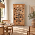 Lifestyle image of a hand-carved mango wood cupboard with Indian peacock design motifs, Mediterranean-style wardrobe; elegant mango wood furniture, 190 × 100 × 40 cm.