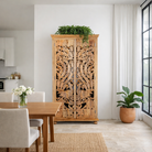 Lifestyle image of a hand-carved mango wood cupboard with Indian peacock design motifs, Mediterranean-style wardrobe; elegant mango wood furniture, 190 × 100 × 40 cm.