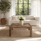 Lifestyle image of a rustic minimalistic coffee table with geometric inlay, reclaimed wood coffee table crafted from sustainable furniture materials, 100 × 100 × 45 cm.