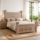 Lifestyle image of a handcrafted four poster bed made from reclaimed wood with carved detailing – Mirai model by Om Home & Garden