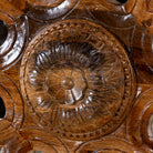 Close up image of a round mango wood mirror Advaith with hand-carved floral frame. A unique wall decor piece combining traditional Indian craftsmanship and organic design.