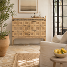 Lifestyle image of a vintage entryway table treasure chest in antique Indian furniture style, solid teak wood with iron accents and sandblasted finish, 113 × 54 × 100 cm.