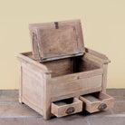 Side angle image with open lid of a Mivaan vintage reclaimed teak wood box with writing lid, small drawers, and restored rustic teak finish.