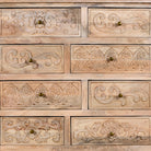 Close up image of a carved mango wood cabinet with drawers and one door, made from reclaimed teak, 100 × 40 × 100 cm.