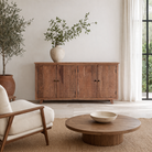 Lifestyle image of a acacia wood cabinet with hand-carved geometric patterns, artisan carved wood furniture for living room storage, 180 × 40 × 90 cm.