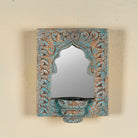 Hand-carved wooden mirror with candle holder in distressed turquoise finish, featuring Indian arch design – ideal for vintage and Indian home accessories.