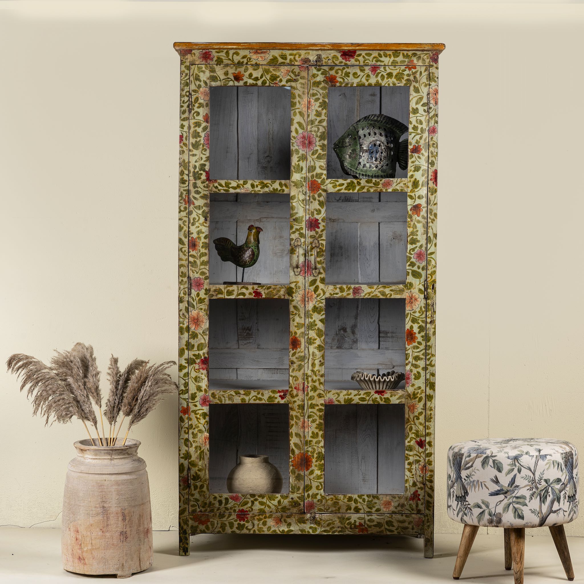 Hand-painted reclaimed wood cabinet with glass doors and floral motifs – sustainable and artistic furniture for vintage or bohemian interiors.