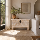 Lifestyle image of a hand‑carved mango wood chest with floral detailing – vintage home accessories and artisan storage chest for stylish interiors.