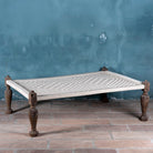 Front view of a handwoven Indian Charpoi bed with reclaimed teak frame and carved legs; perfect for Indian home decor, 174 × 122 × 60 cm.
