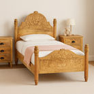 Wooden bed with intricate carvings in a bedroom setting
