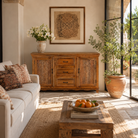 Lifestyle image of a Naren Natural hand carved mango wood sideboard with floral carved doors 150cm