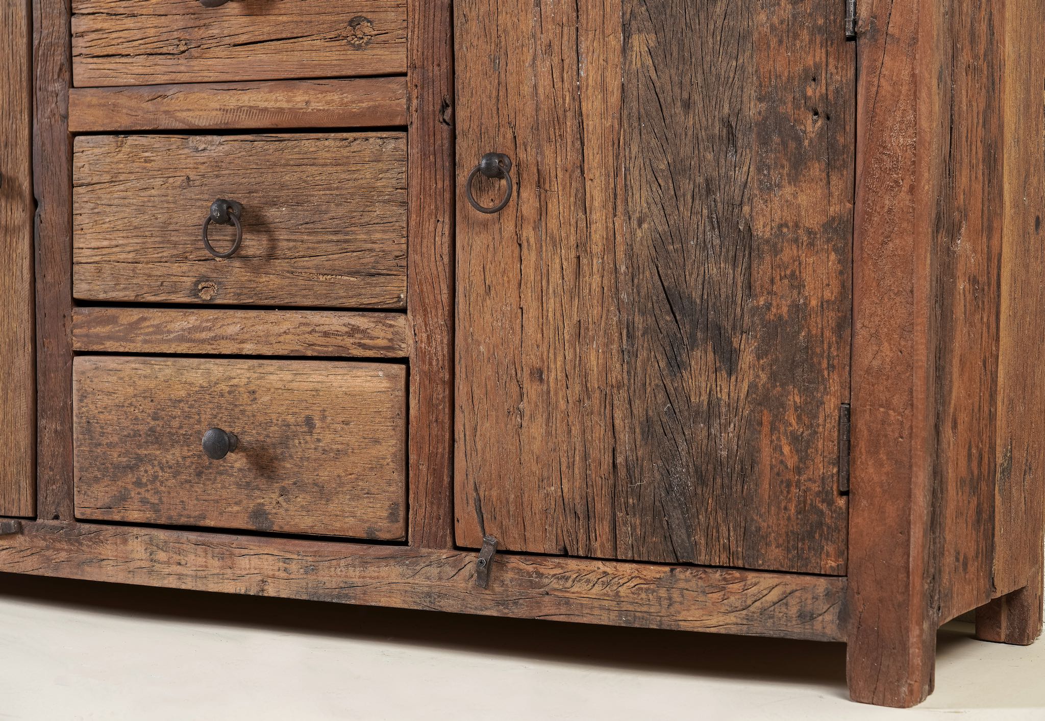 Close up image of a storage rustic sideboard made of reclaimed wood with 3 drawers and 2 doors.