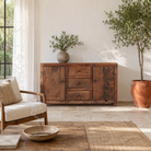 Lifestyle image of a storage rustic sideboard made of reclaimed wood with 3 drawers and 2 doors.