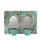 White background image of a double arched hand-carved wooden mirror in distressed turquoise finish with two candle holders – ideal for Indian and vintage home accessories.