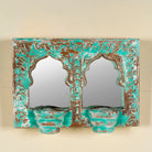 Double arched hand-carved wooden mirror in distressed turquoise finish with two candle holders – ideal for Indian and vintage home accessories.