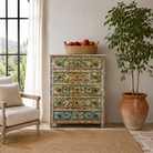 Lifestyle image of a of a Neel hand painted reclaimed wood chest of drawers with five floral drawers and colourful boho vintage finish.