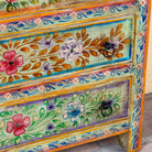 Close up image of a Neel hand painted reclaimed wood chest of drawers with five floral drawers and colourful boho vintage finish.