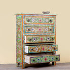 Side angle image with open drawers of a Neel hand painted reclaimed wood chest of drawers with five floral drawers and colourful boho vintage finish.