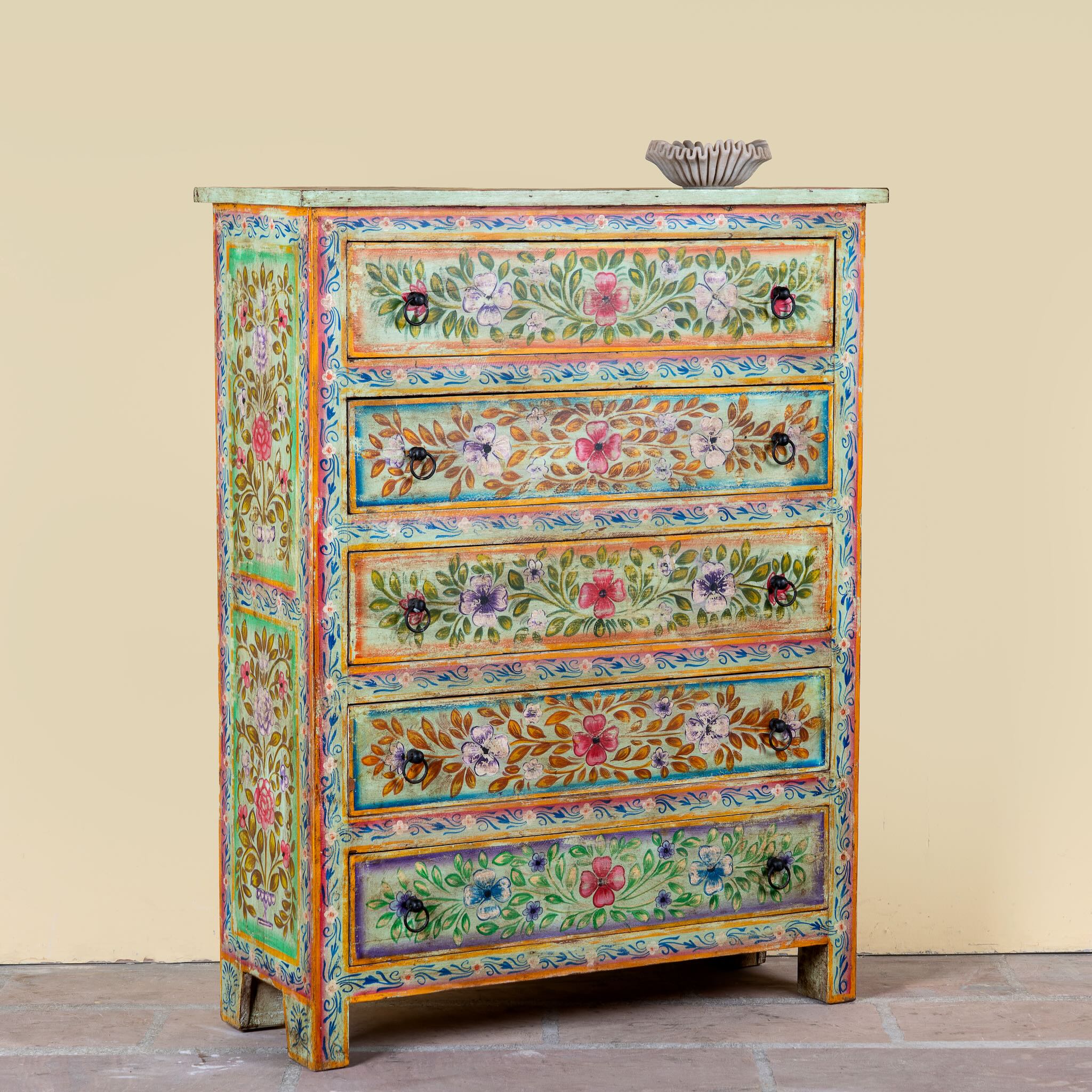 Close up image of a Neel hand painted reclaimed wood chest of drawers with five floral drawers and colourful boho vintage finish.