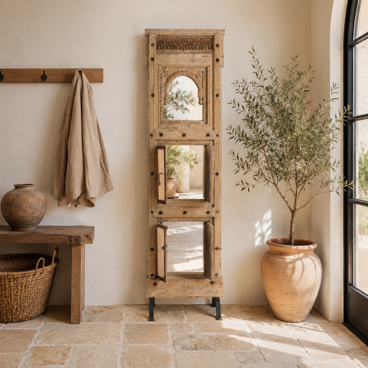 White background image of a unique Indian mirror stand Neha made from recycled teak wood with carved panels and iron base. A multifunctional boho wall decor piece combining storage and sustainable design.