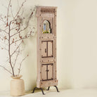 Side angle image of a mirror stand crafted from reclaimed teak wood with intricate carved detailing and two storage cabinets, set on a sturdy iron base, blending rustic charm with vintage Indian architectural elements.
