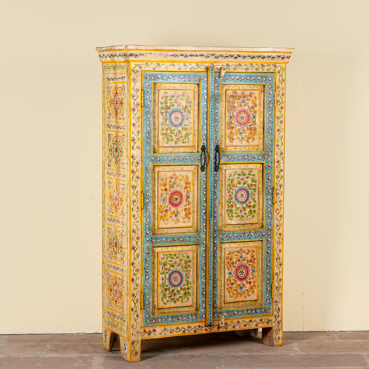 Side angle image of a Nehrika hand painted reclaimed wood cabinet with colourful floral double doors and three storage compartments, 150cm
