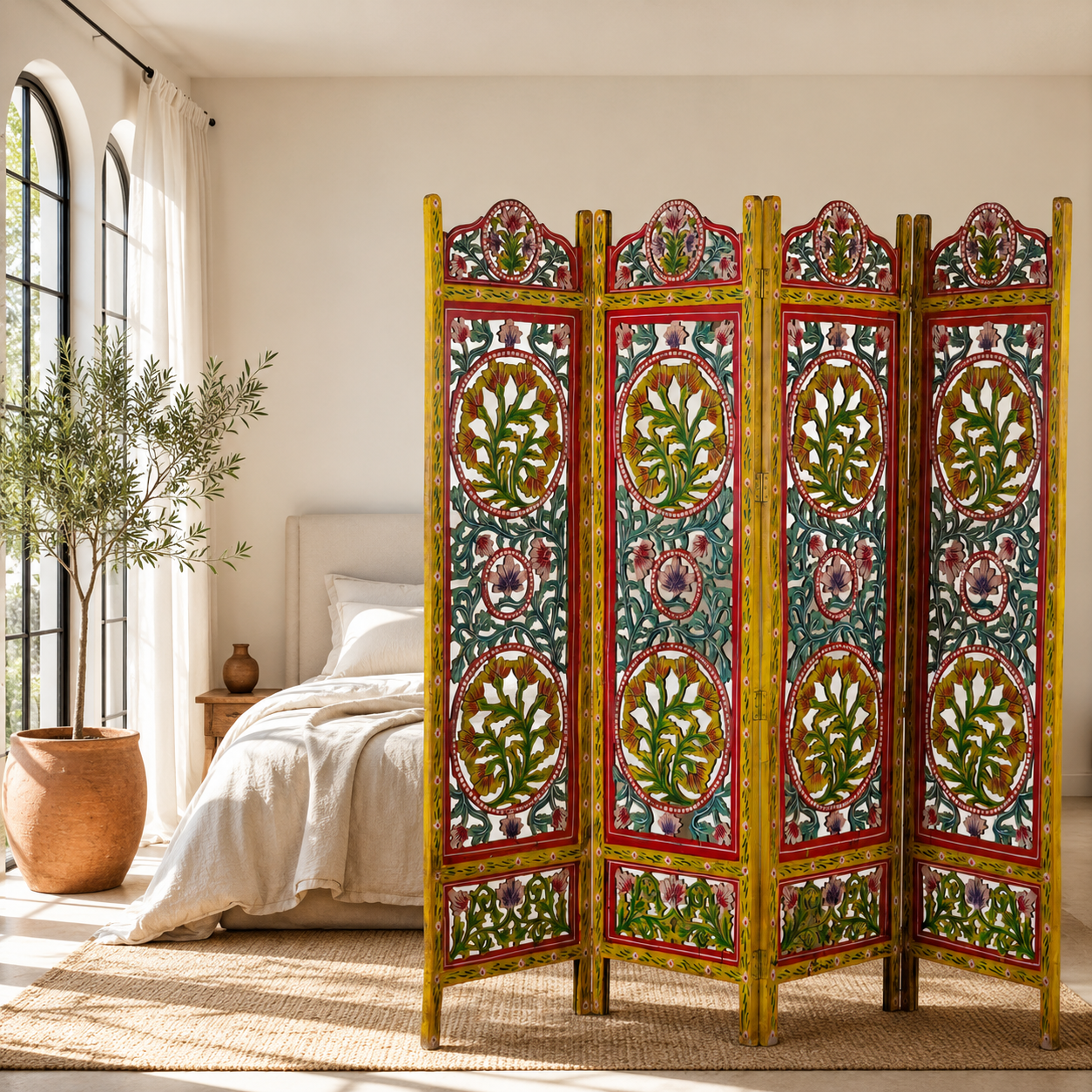 Lifestyle image of a hand carved and hand painted mango wood room divider with colourful floral Indian motifs and folding panels.
