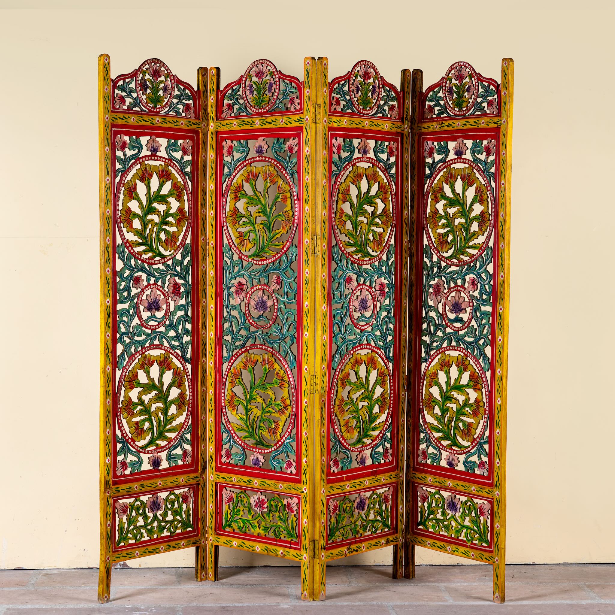 Hand carved and hand painted mango wood room divider with colourful floral Indian motifs and folding panels.
