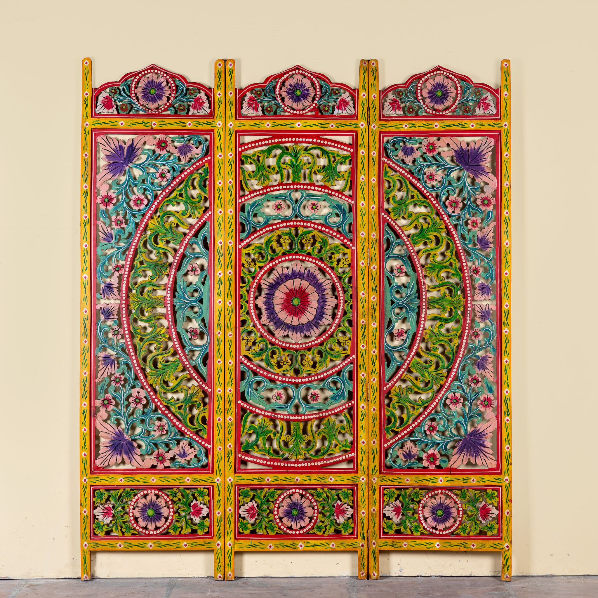 Hand carved and hand painted mango wood room divider with colourful floral Indian motifs and folding panels.