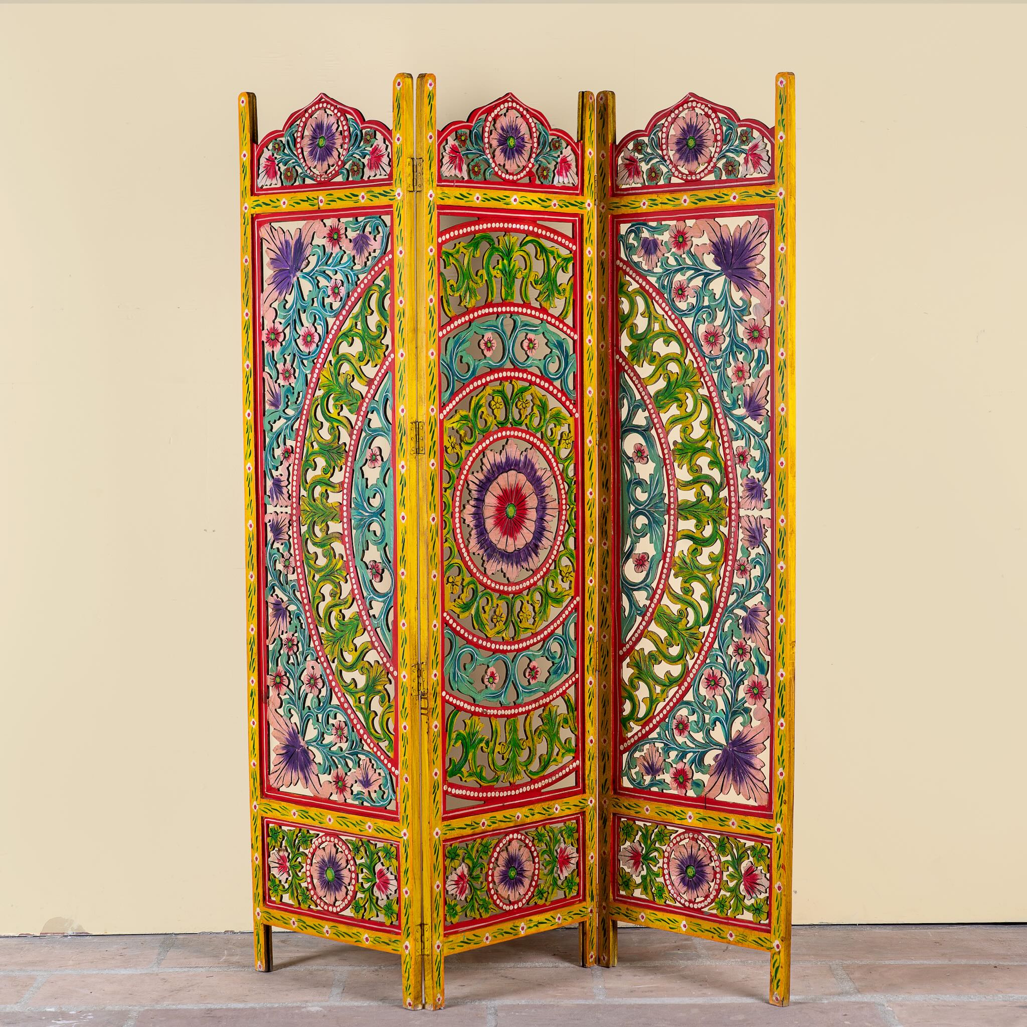 Hand carved and hand painted mango wood room divider with colourful floral Indian motifs and folding panels.